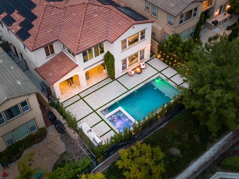 Aerial twilight view of the backyard pool and patio string lights — Aliso Viejo real estate photography