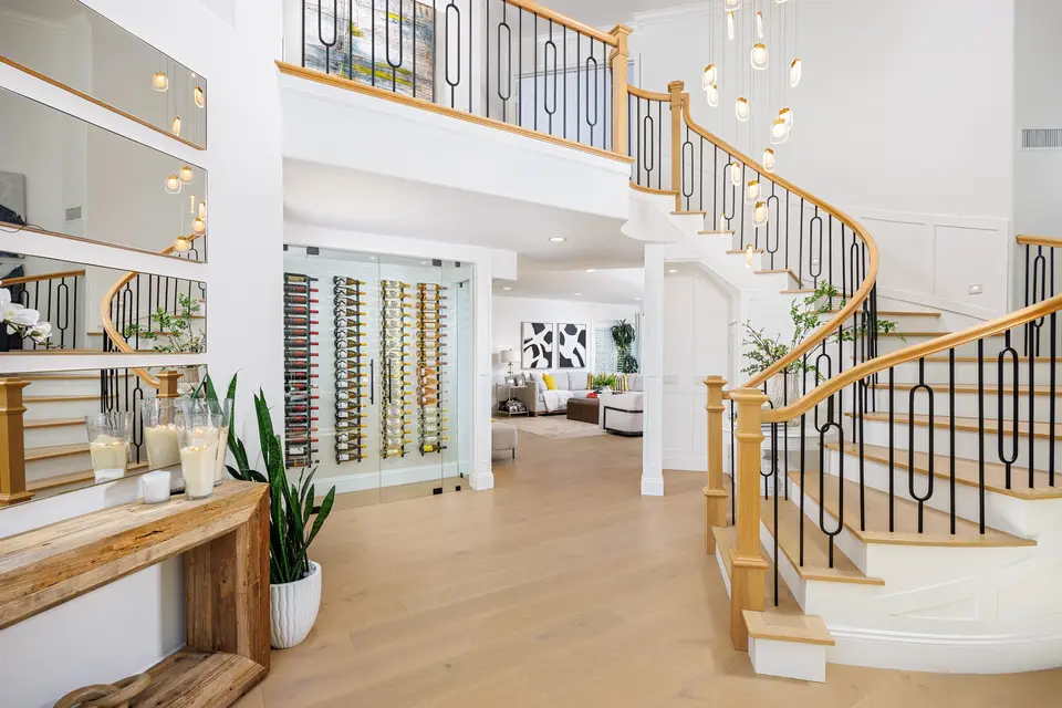Entryway with staircase, chandelier, and built-in wine storage, Aliso Viejo