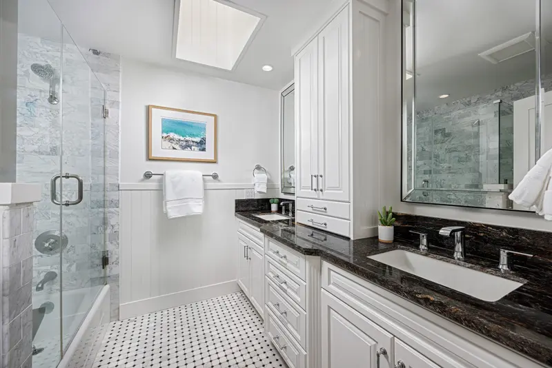 Bathroom with dark granite double vanity — Corona del Mar real estate photography