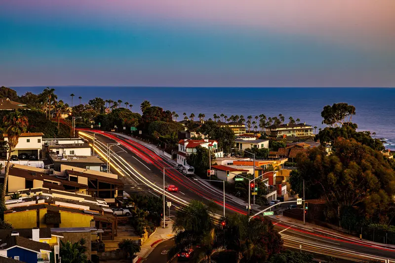 Long-exposure street view at dusk with light trails — Laguna Beach real estate photography