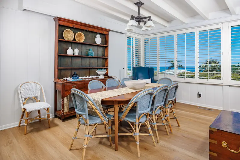 Dining room with ocean view through shutters — Laguna Beach real estate photography
