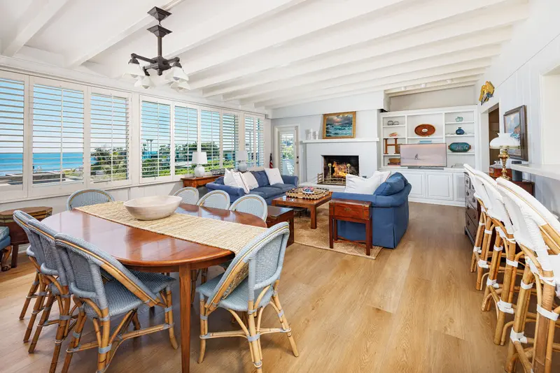 Living and dining room with fireplace and ocean view — Laguna Beach real estate photography