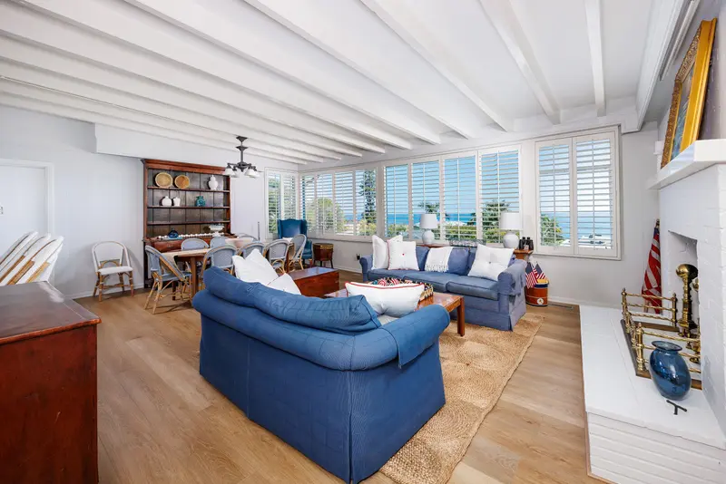 Living room with ocean view through plantation shutters — Laguna Beach real estate photography