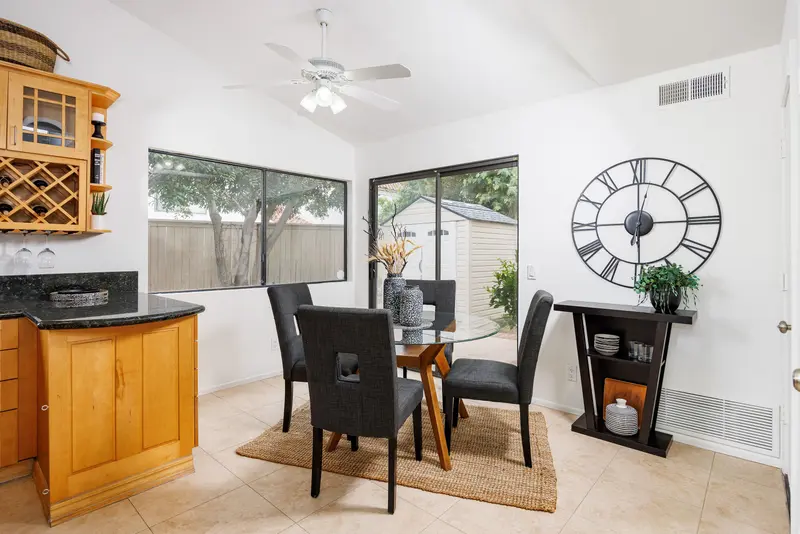 Breakfast nook with glass table and backyard view — Lake Forest real estate photography