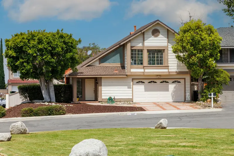 Two-story home exterior with mature landscaping — Lake Forest real estate photography