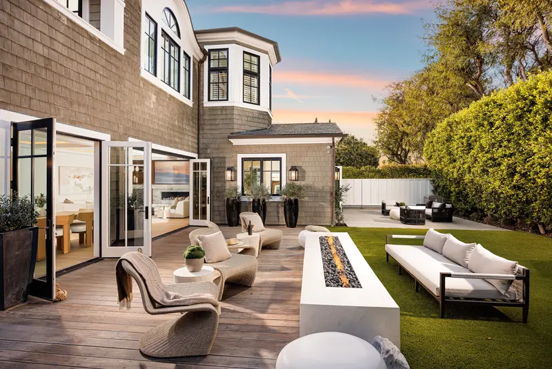 Backyard fire trough and lounge seating at twilight — Newport Beach real estate photography