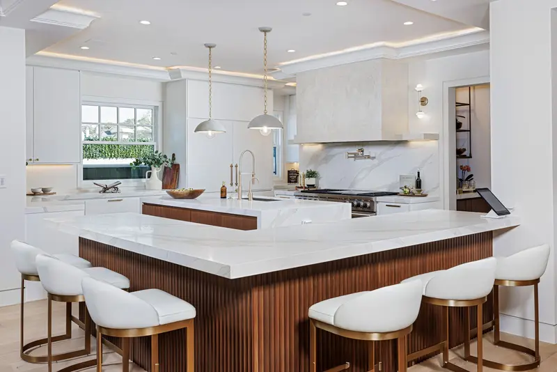 Kitchen with waterfall island and walnut cabinetry — Newport Beach real estate photography