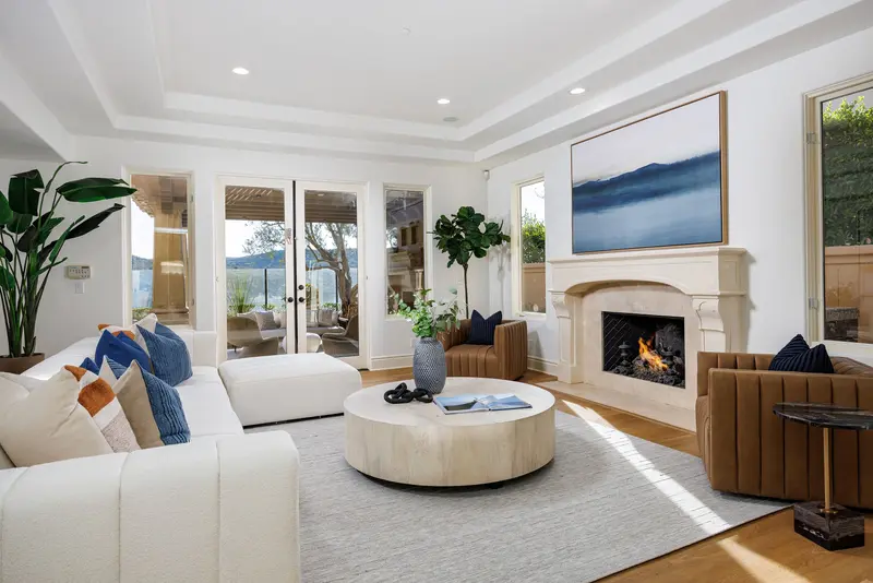Family room with tray ceiling and canyon-view art — Newport Coast real estate photography