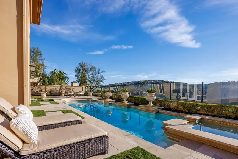 Pool and spa cut into the hillside with canyon views — Newport Coast real estate photography