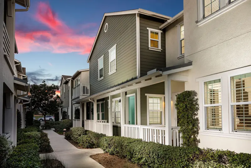 Townhome exterior at dusk along a front-porch walkway — Rancho Mission Viejo real estate photography