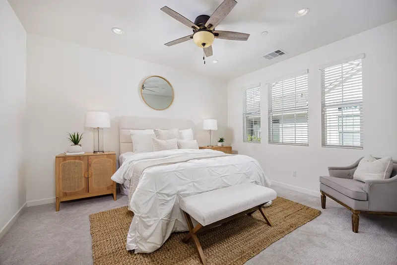 Primary bedroom with round mirror and jute rug — Rancho Mission Viejo real estate photography